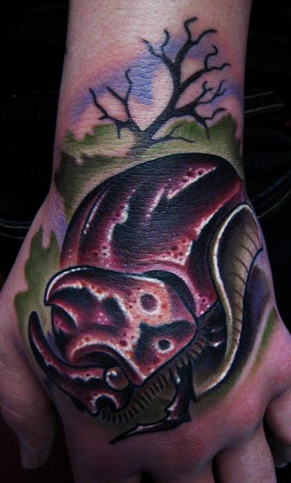 Jonathan Montalvo - rhino bug hand tattoo